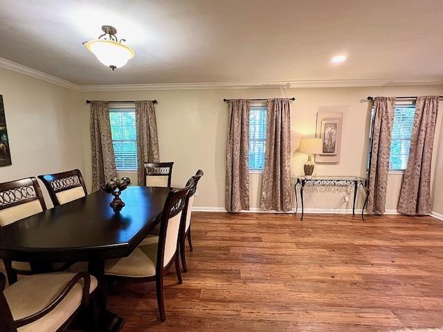 2401 Mexia Ave, Tallahassee, FL 32304 - dining room featuring crown molding, baseboards, and wood finished floors