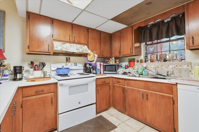 1292 Rumba Ln -, Unit Tallahassee, FL 32304 - kitchen featuring white range with electric stovetop, stainless steel microwave, under cabinet range hood, light tile patterned flooring, and light countertops