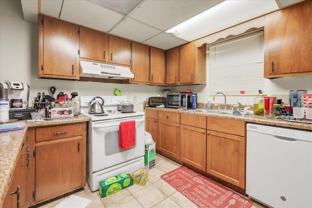 1292 Rumba Ln -, Unit Tallahassee, FL 32304 - kitchen with white appliances, under cabinet range hood, light tile patterned floors, light countertops, and a paneled ceiling