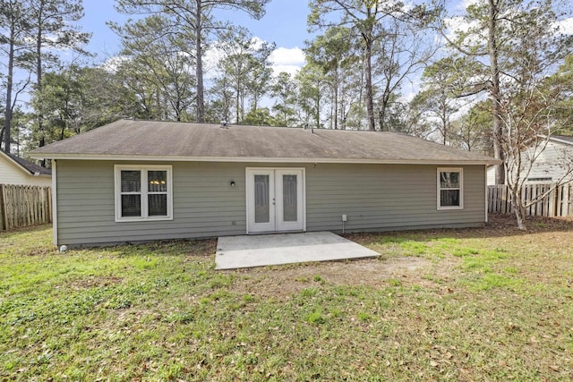 rear view of property with a yard, a patio area, and french doors