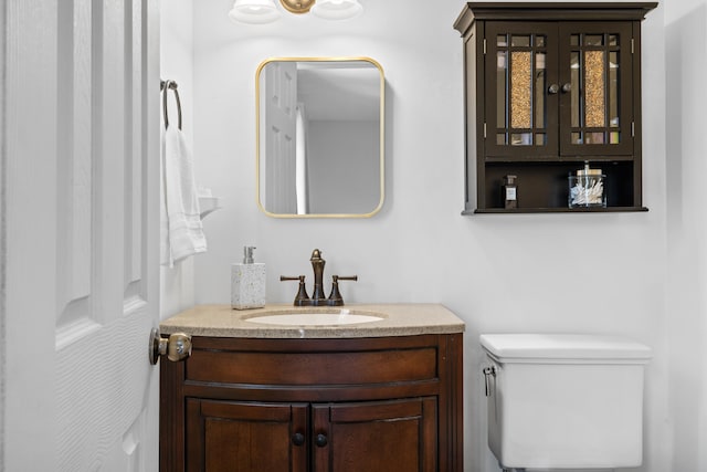 bathroom with toilet and vanity