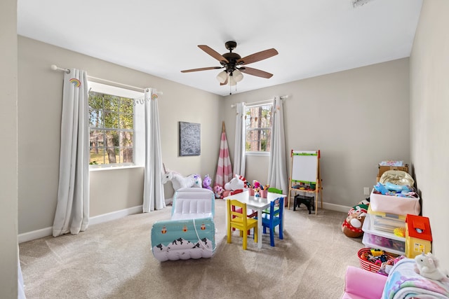 recreation room featuring carpet floors, ceiling fan, and baseboards