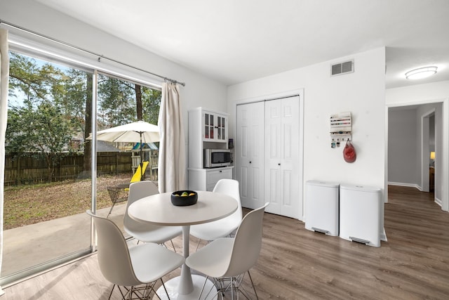 dining area featuring visible vents and wood finished floors