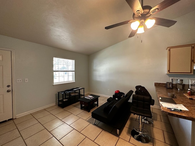 living room featuring ceiling fan, light tile patterned flooring, and lofted ceiling