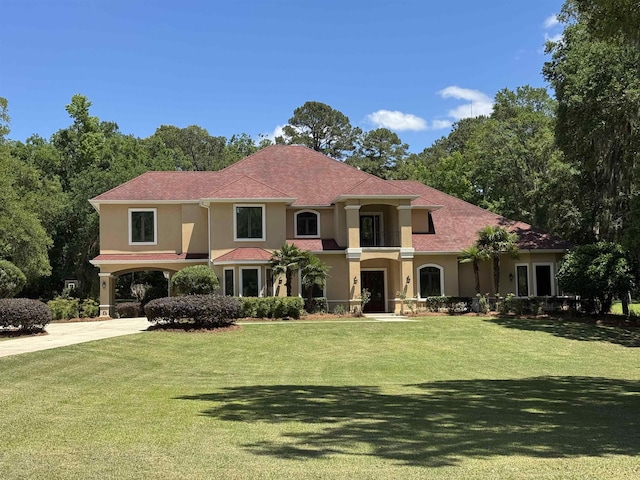 8017 Oak Grove Plantation Rd, Tallahassee, FL 32312 - mediterranean / spanish-style home with stucco siding, a front yard, and concrete driveway