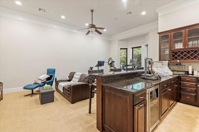 8017 Oak Grove Plantation Rd, Tallahassee, FL 32312 - kitchen featuring wine cooler, a kitchen bar, ceiling fan, dark stone counters, and crown molding