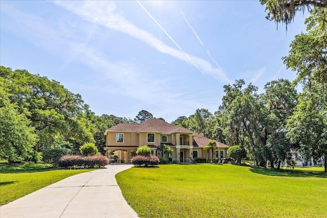 8017 Oak Grove Plantation Rd, Tallahassee, FL 32312 - mediterranean / spanish house featuring stucco siding, driveway, and a front yard