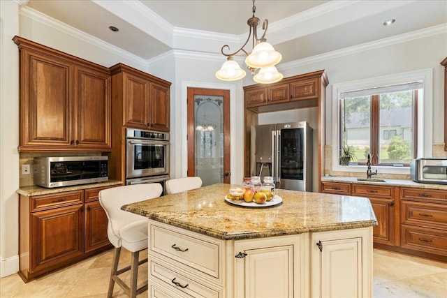 8017 Oak Grove Plantation Rd, Tallahassee, FL 32312 - kitchen featuring appliances with stainless steel finishes, a sink, light stone countertops, a center island, and a kitchen bar