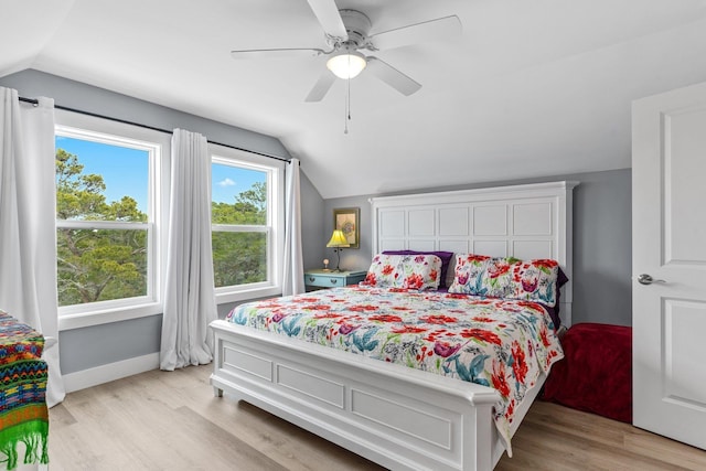 bedroom with lofted ceiling, ceiling fan, and light wood-type flooring