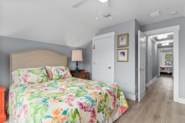 bedroom with lofted ceiling, ceiling fan, and light hardwood / wood-style flooring