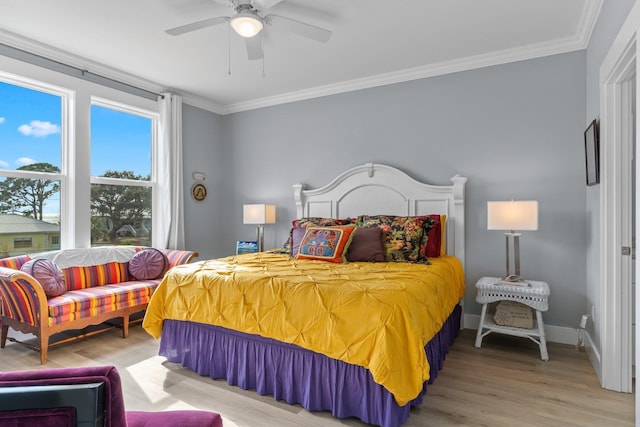 bedroom featuring crown molding, light hardwood / wood-style floors, and ceiling fan