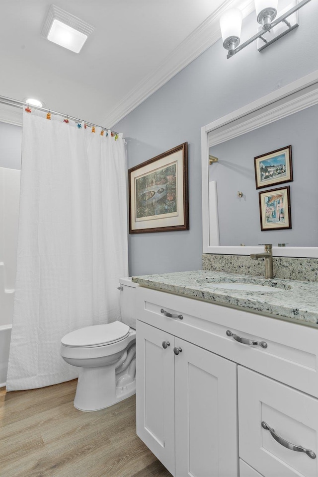 bathroom featuring hardwood / wood-style flooring, vanity, ornamental molding, and toilet