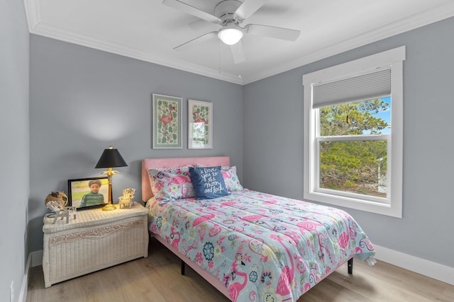 bedroom featuring ornamental molding, ceiling fan, and light hardwood / wood-style flooring