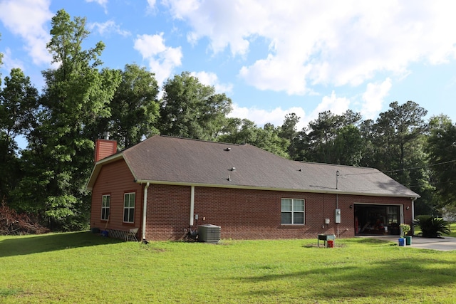 325 Mine Rd, Midway, FL 32343 - rear view of property with a garage, a chimney, a yard, and brick siding