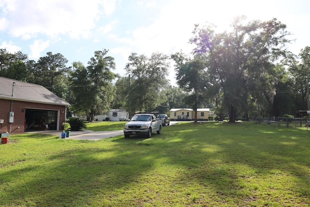 325 Mine Rd, Midway, FL 32343 - view of grassy yard with a garage and view of scattered trees