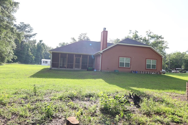 325 Mine Rd, Midway, FL 32343 - back of house with a sunroom, a chimney, a lawn, and roof with shingles