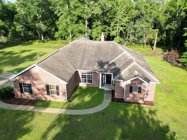 325 Mine Rd, Midway, FL 32343 - view of front facade featuring brick siding, a front yard, and roof with shingles