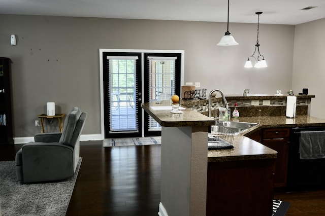 325 Mine Rd, Midway, FL 32343 - kitchen with black dishwasher, dark wood-style floors, hanging light fixtures, dark countertops, and dark brown cabinetry