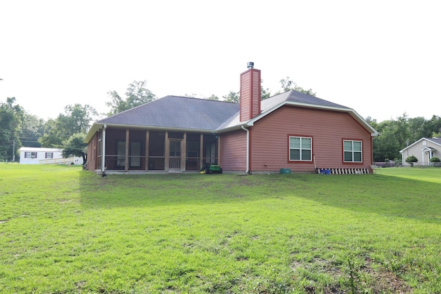 325 Mine Rd, Midway, FL 32343 - rear view of property with a sunroom, a chimney, a lawn, and roof with shingles