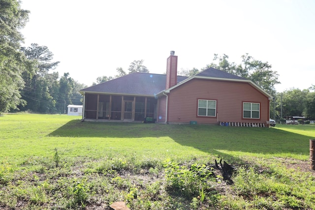 325 Mine Rd, Midway, FL 32343 - back of house featuring a sunroom, a yard, and a chimney