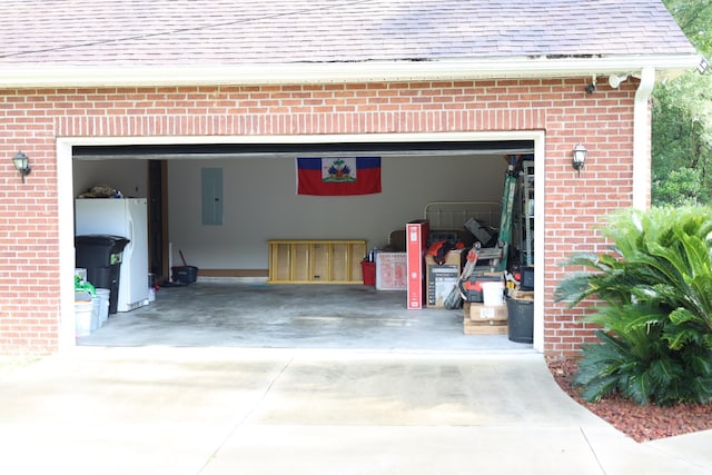 325 Mine Rd, Midway, FL 32343 - garage featuring electric panel, freestanding refrigerator, and concrete driveway
