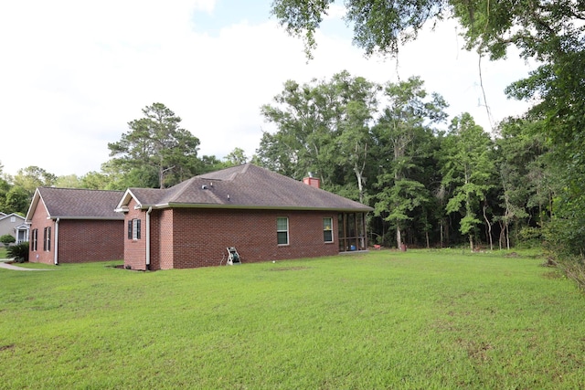 325 Mine Rd, Midway, FL 32343 - view of side of property with a lawn, brick siding, and a chimney