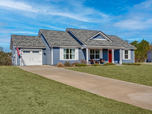 view of front of house featuring a garage, a porch, and a front lawn