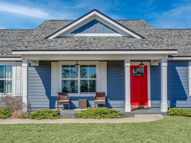 property entrance featuring a porch and a lawn