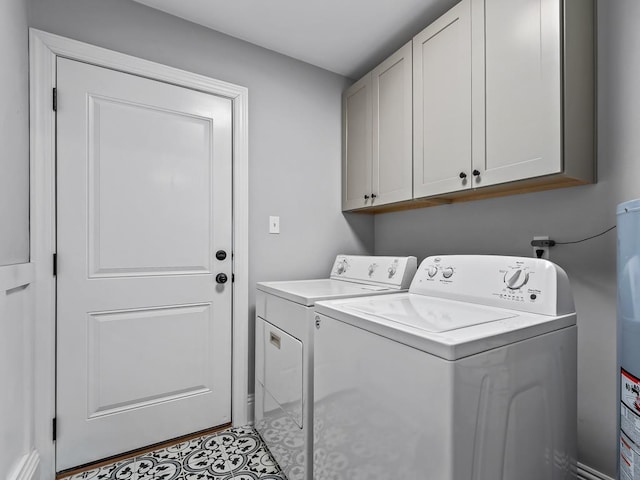 washroom with washing machine and dryer and cabinets