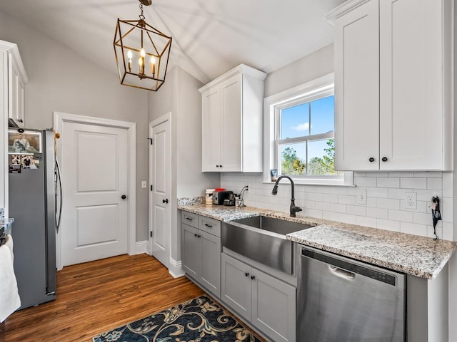 kitchen featuring sink, decorative light fixtures, stainless steel appliances, decorative backsplash, and white cabinets