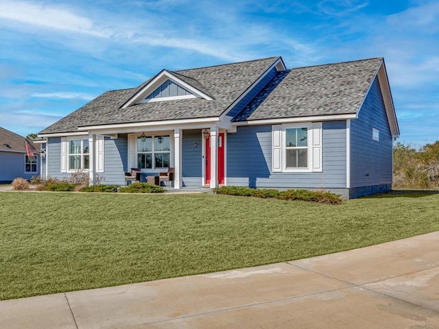 view of front of property featuring covered porch and a front lawn