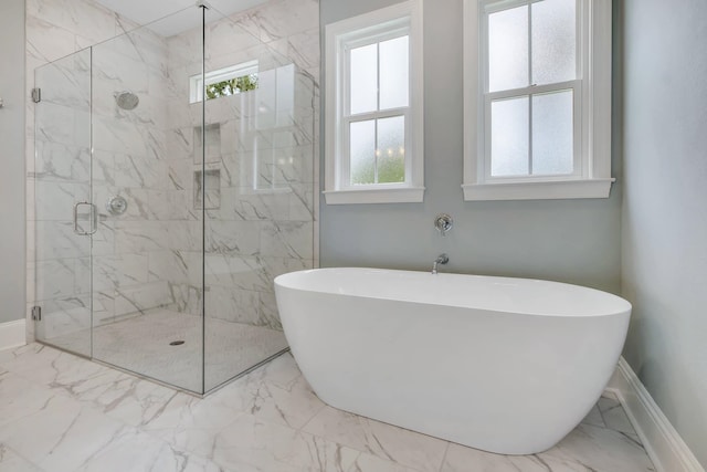 bathroom featuring plus walk in shower and a wealth of natural light