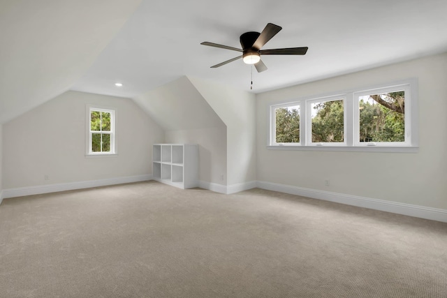 bonus room featuring light carpet, lofted ceiling, and ceiling fan