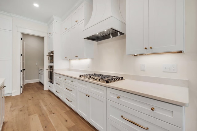 kitchen with stainless steel appliances, light hardwood / wood-style floors, custom exhaust hood, and white cabinets