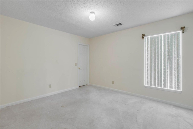 4545 Thomasville Rd, Tallahassee, FL 32309 - empty room with a textured ceiling, light colored carpet, and baseboards