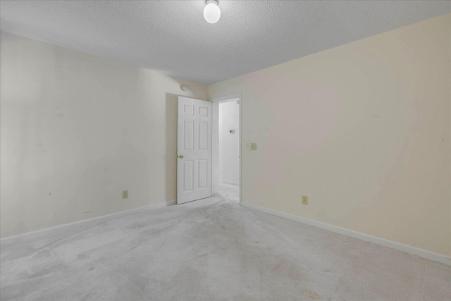 4545 Thomasville Rd, Tallahassee, FL 32309 - carpeted empty room with a textured ceiling and baseboards