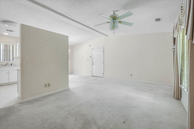 4545 Thomasville Rd, Tallahassee, FL 32309 - empty room with a ceiling fan, light carpet, a textured ceiling, baseboards, and healthy amount of natural light