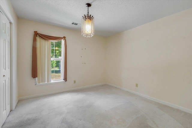 4545 Thomasville Rd, Tallahassee, FL 32309 - spare room featuring a chandelier, light colored carpet, baseboards, and a textured ceiling