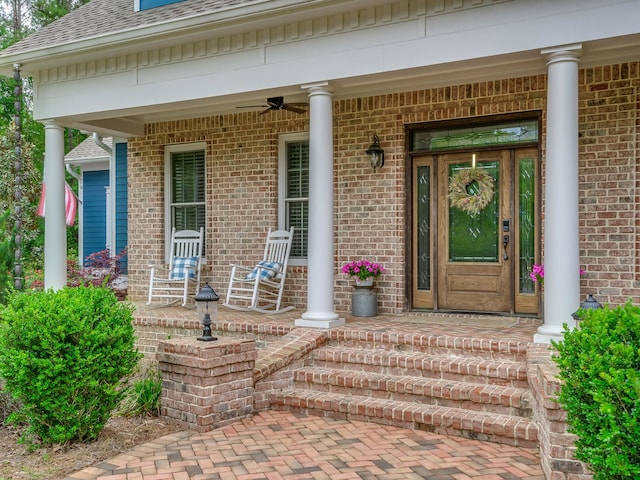 doorway to property featuring ceiling fan and a porch