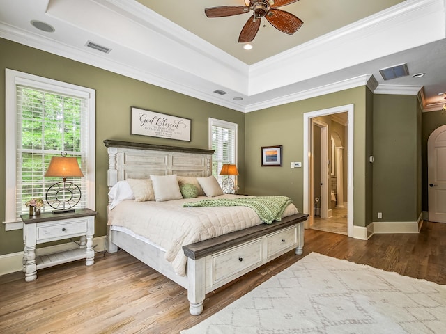 bedroom featuring crown molding, hardwood / wood-style flooring, and ceiling fan