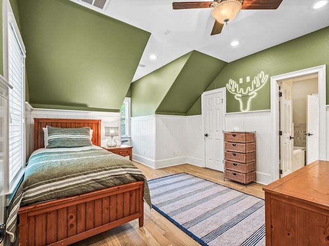 bedroom featuring ceiling fan, lofted ceiling, and light hardwood / wood-style floors