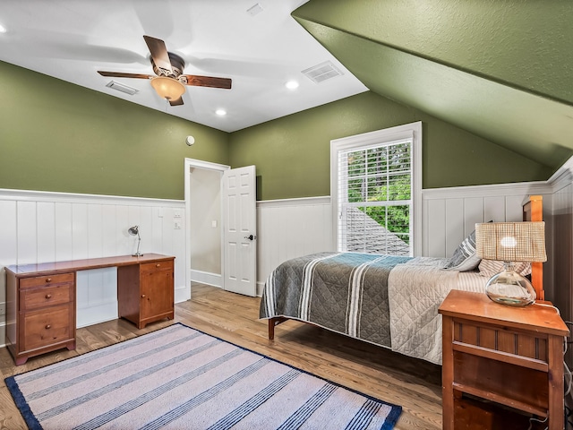 bedroom with hardwood / wood-style floors, ceiling fan, and lofted ceiling