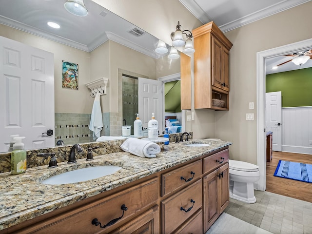 bathroom with ornamental molding, vanity, hardwood / wood-style floors, toilet, and ceiling fan