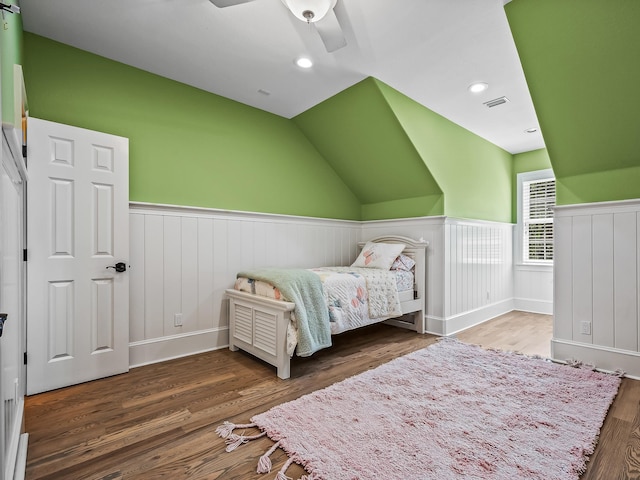 bedroom featuring dark hardwood / wood-style flooring, lofted ceiling, and ceiling fan