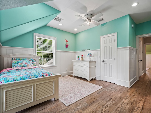 bedroom featuring lofted ceiling, wood-type flooring, and ceiling fan