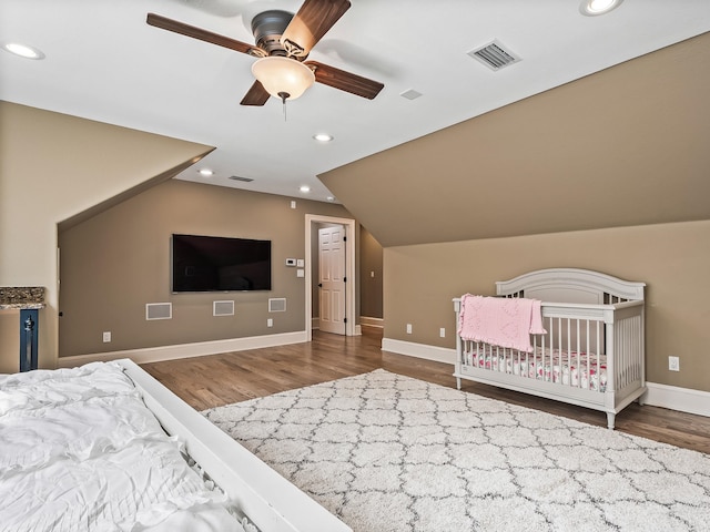 unfurnished bedroom featuring lofted ceiling, hardwood / wood-style flooring, and ceiling fan