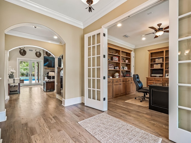 office area with light hardwood / wood-style floors, ceiling fan, crown molding, and french doors