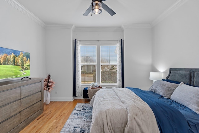 bedroom featuring ornamental molding, light hardwood / wood-style flooring, and ceiling fan