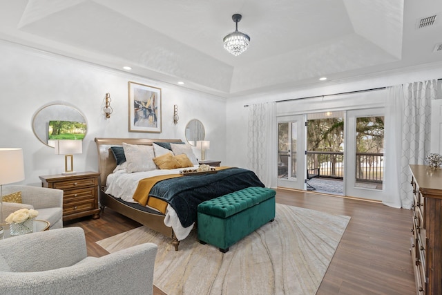 bedroom featuring crown molding, access to outside, dark hardwood / wood-style flooring, and a raised ceiling