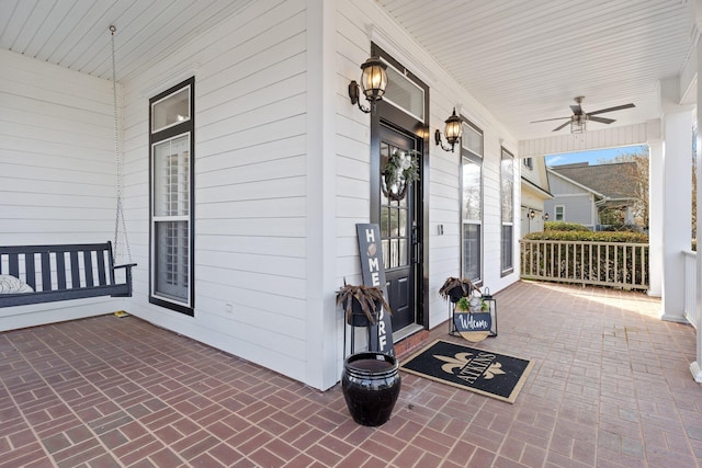 view of patio / terrace with ceiling fan and a porch